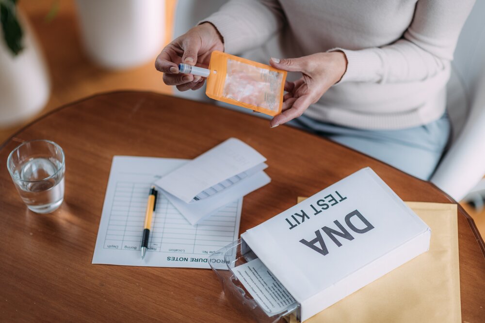 a person putting a test tube on a brown envelope